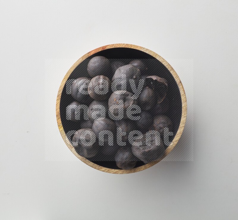 Top-view shot of dried lime (loomi) in a container on white background