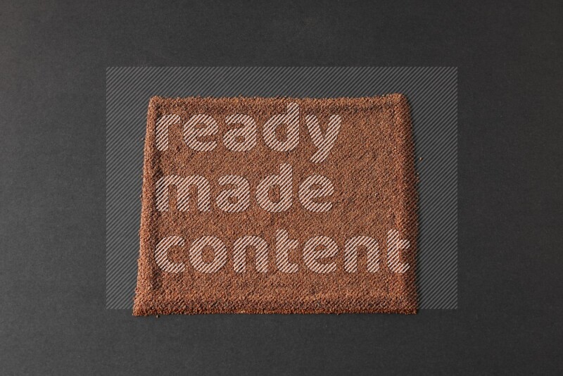 Garden cress seeds filling the frame on a black flooring