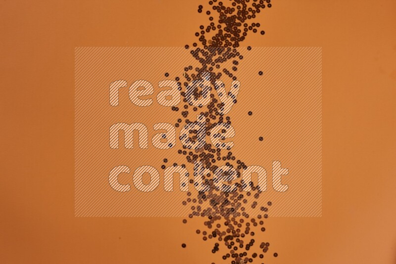 An orange collection of sewing and tailoring tools arranged on a orange background