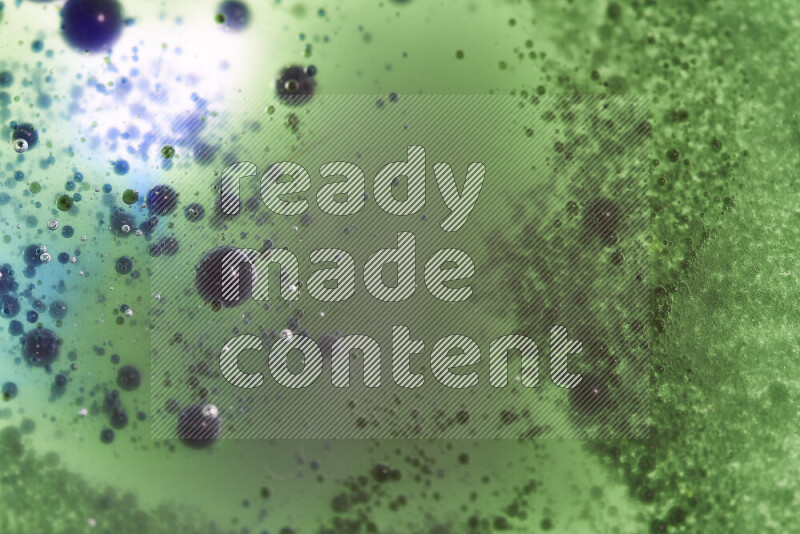 Close-ups of abstract green and blue watercolor drops on oil Surface on white background