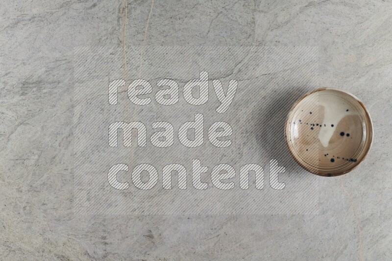 A multicolored pottery Bowl on grey marble background