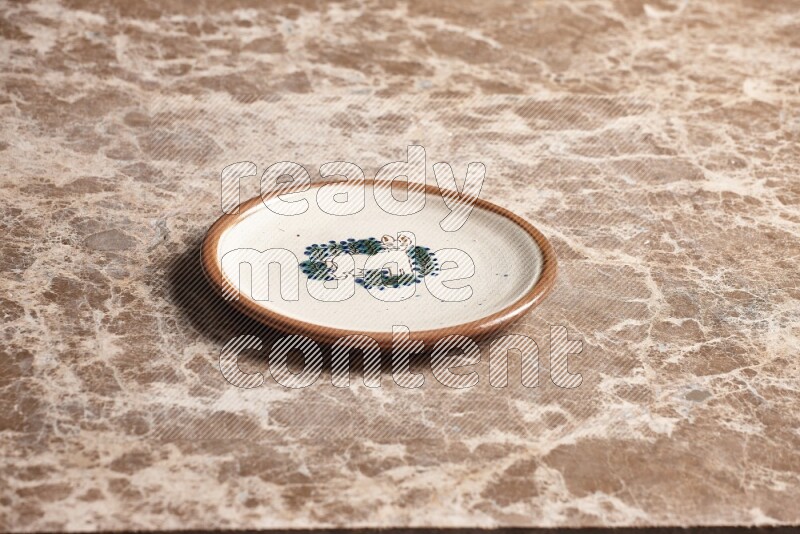 Decorative Pottery Plate on Beige Marble Flooring