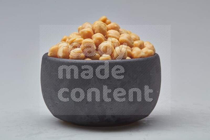 Close up of a boiled chickpeas in a container on white background