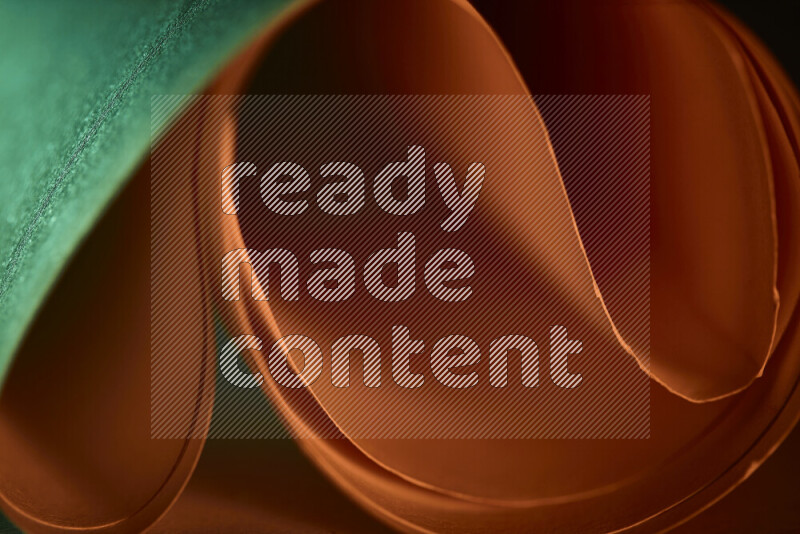 An abstract art piece displaying smooth curves in green and orange gradients created by colored light