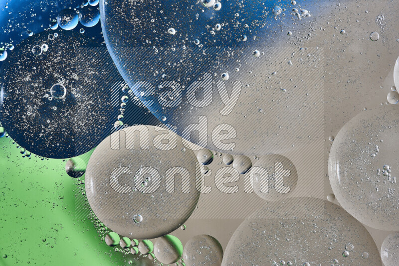 Close-ups of abstract oil bubbles on water surface in shades of brown, green and blue