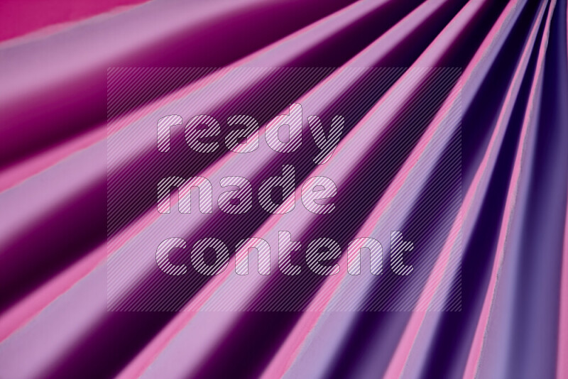 An image presenting an abstract paper pattern of lines in purple tones
