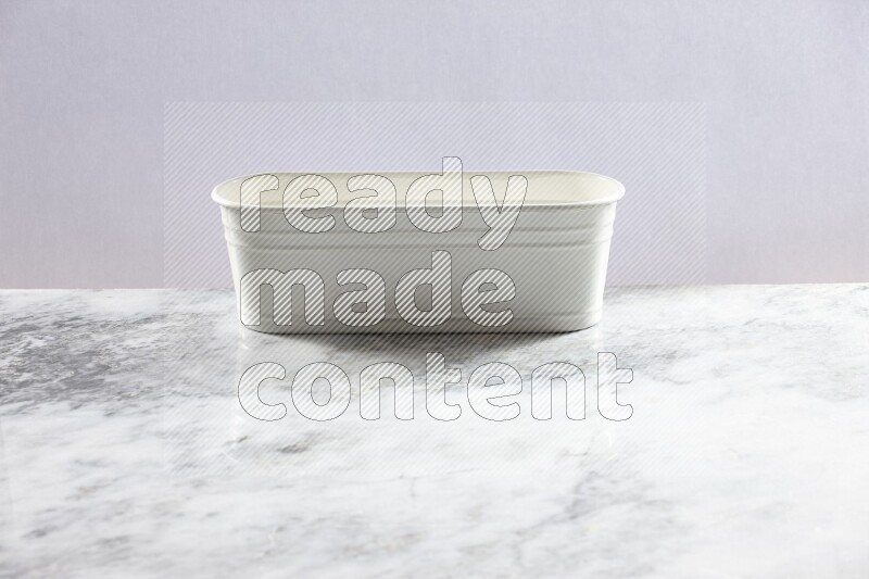 An empty white plant pot on grey marble background