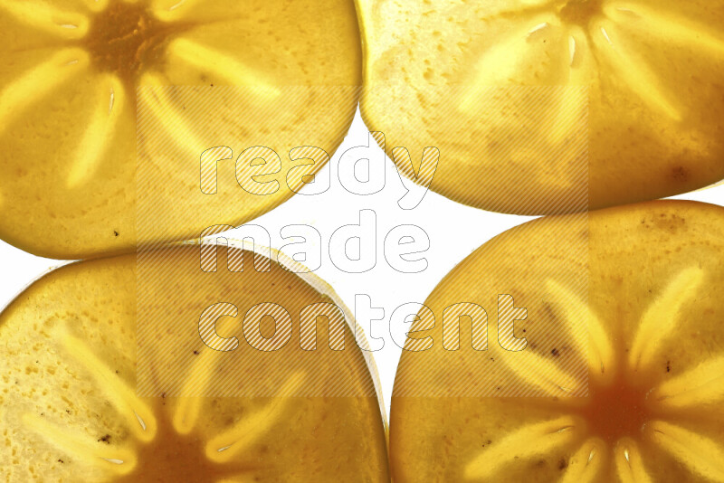 Persimmon slices on illuminated white background