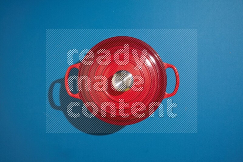 red and white pan and pot on blue background