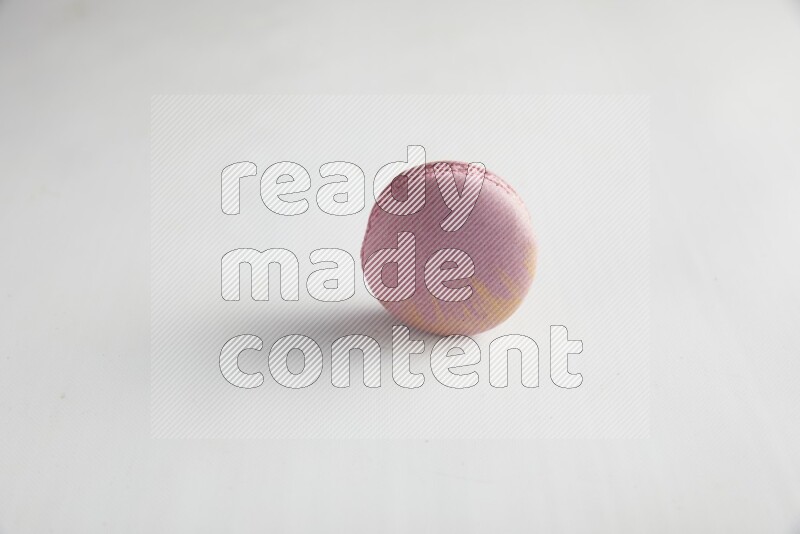 45º Shot of Purple Strawberry macaron on white background