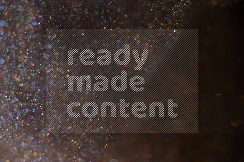 Multicolored glitter powder isolated on black background