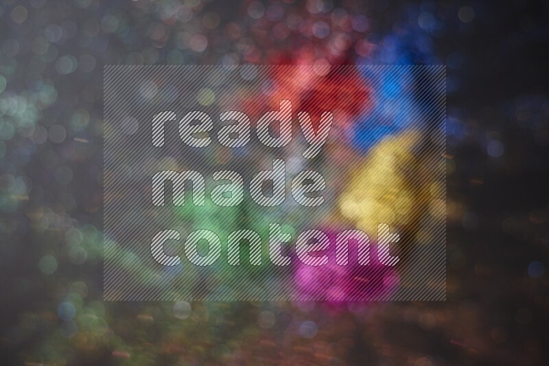 Multicolored glitter powder isolated on black background