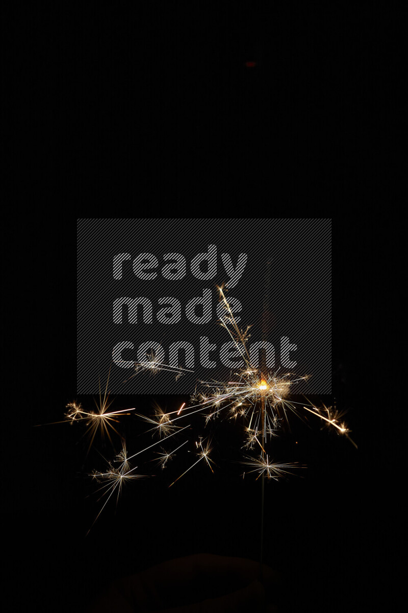A close-up image of sparkler candle isolated on black background