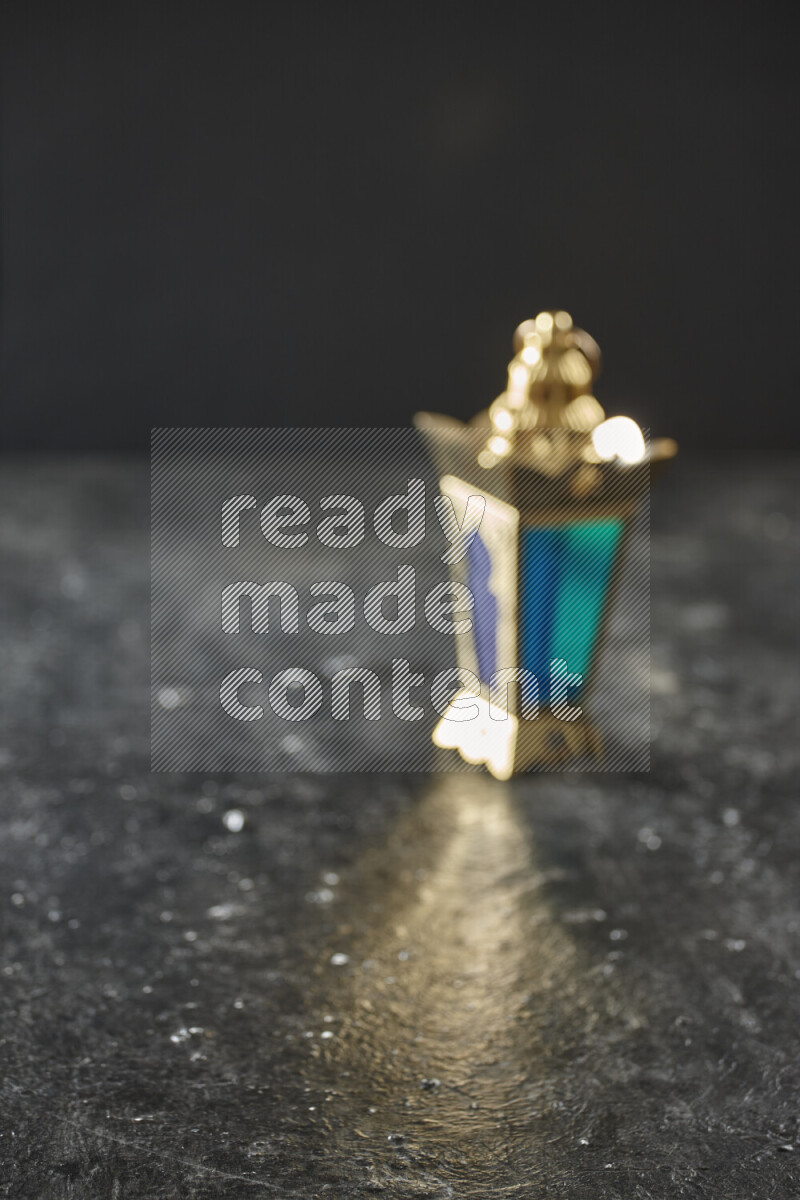 A lantern placed on a textured black background