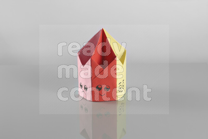 Origami pen holder on grey background
