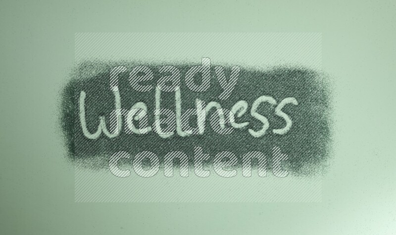 A word written with green glitter on green background