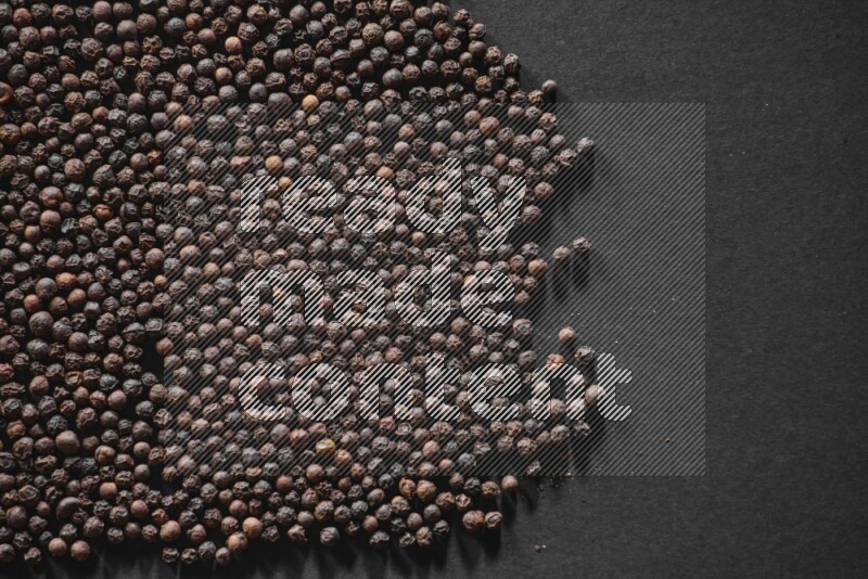 Black pepper on a black flooring