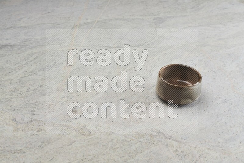 A multicolored pottery bowl on grey marble background
