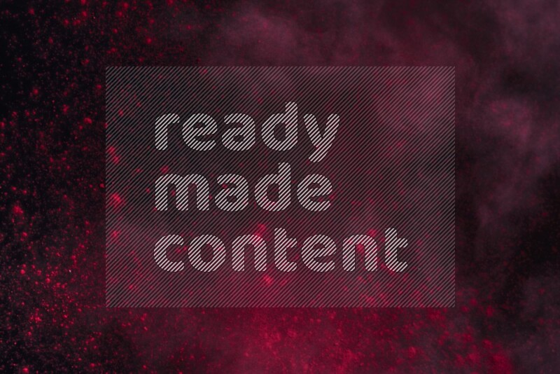 Red powder explosion on black background