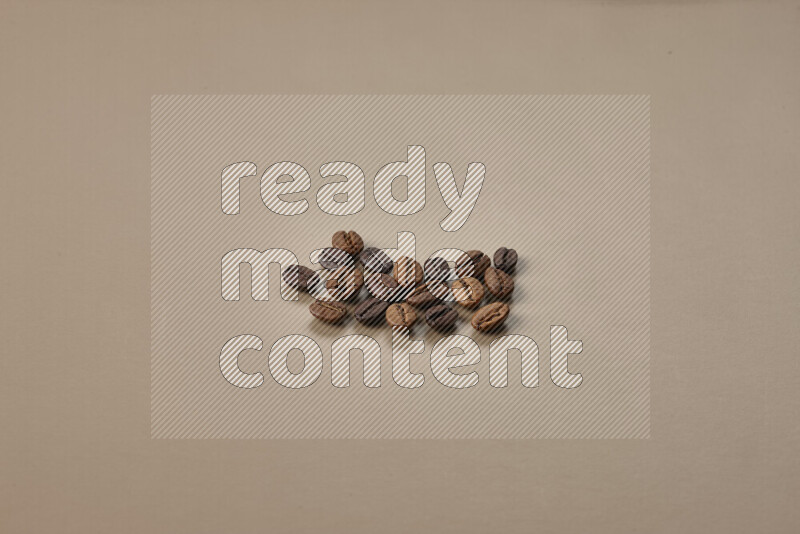 Roasted coffee beans on beige background