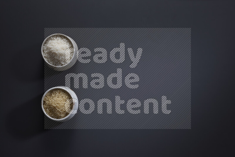 Legumes in pottery bowls on grey background