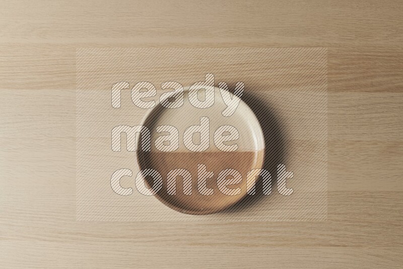A multicolored pottery oven plate on light wooden background