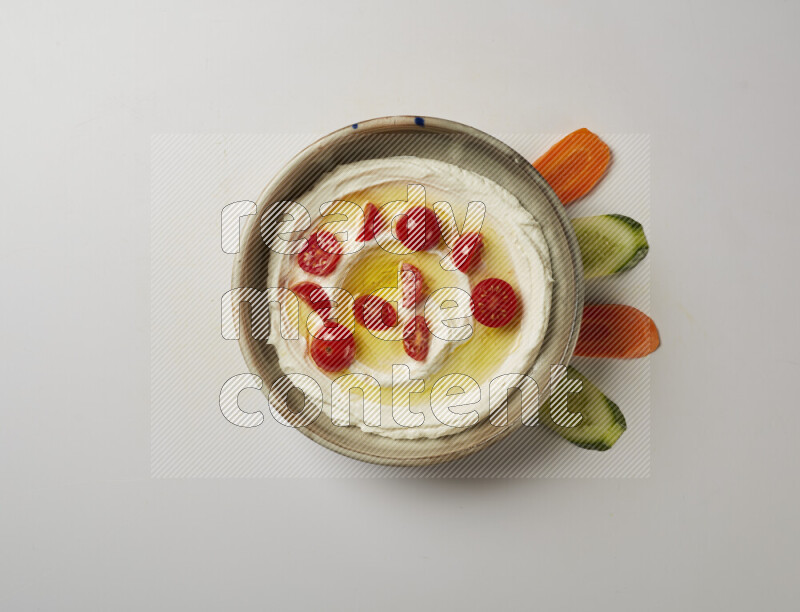 Lebnah garnished with cherry tomato in a grey pottery plate on a white background