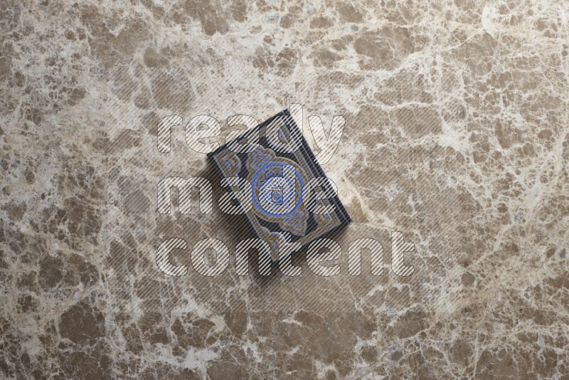The holy Quran on beige marble background