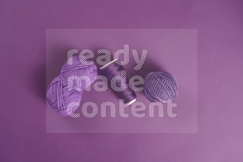 A purple collection of sewing and tailoring tools arranged on a purple background