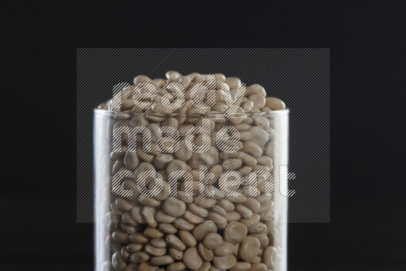 Lupin Beans in a glass jar on black background