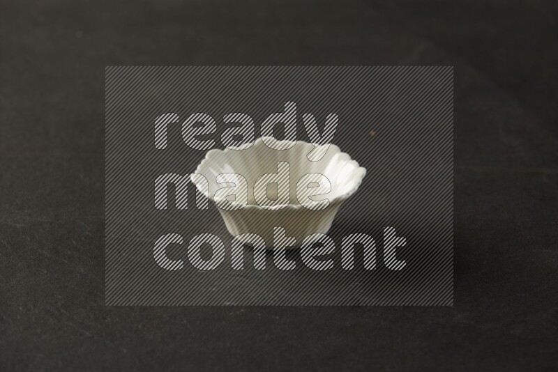 white ceramic round sauce bowl on grey textured countertop