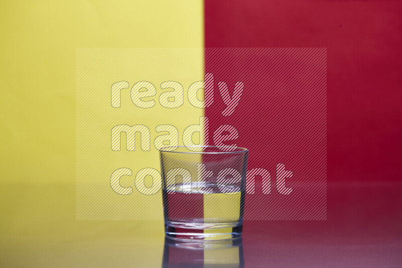 The image features a clear glassware filled with water, set against yellow and red background