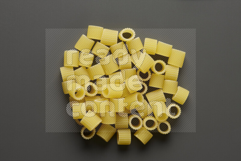 Big rings pasta on grey background