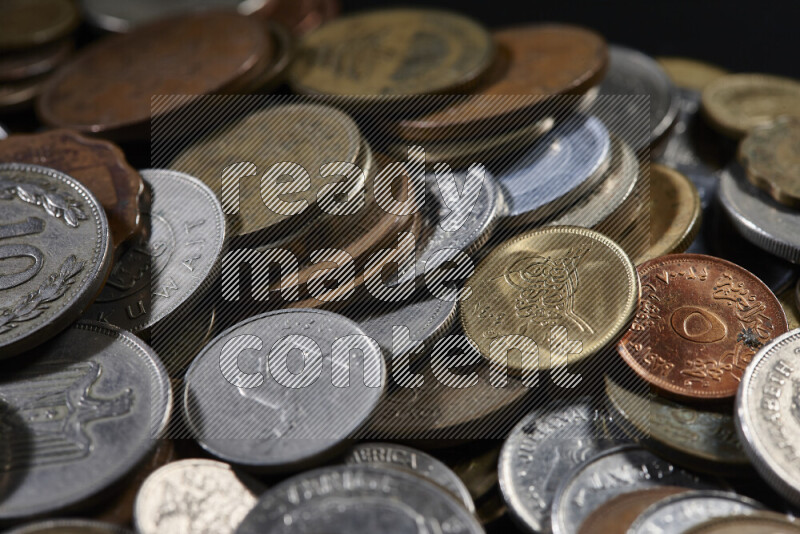 A close-ups of random old coins on black background