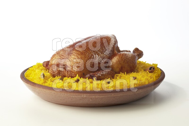 yellow basmati Rice with whole roasted chicken  on a pottery plate  direct  on white background