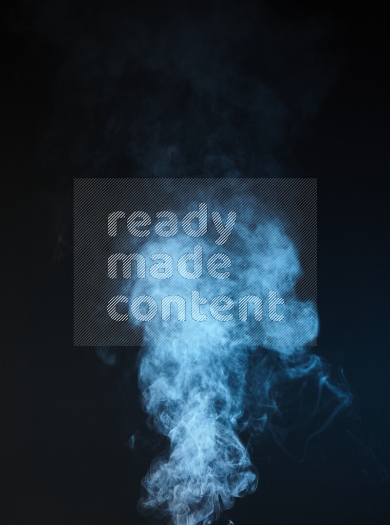 Heavy smoke in blue isolated on black background