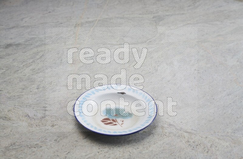 A vintage metal plate on grey marble background