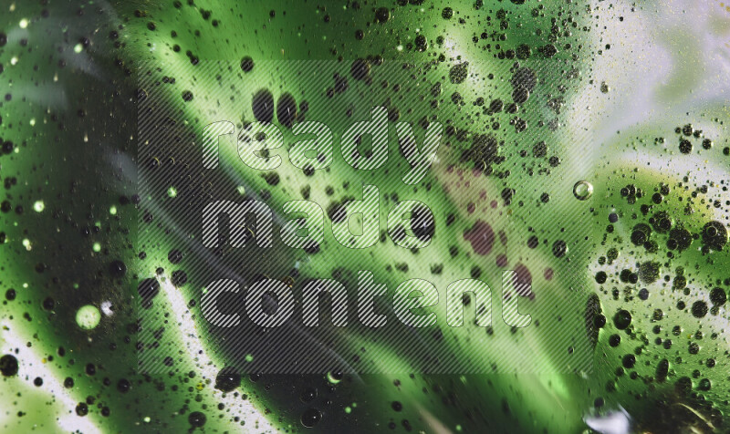 Close-ups of abstract green watercolor drops on oil Surface on white background