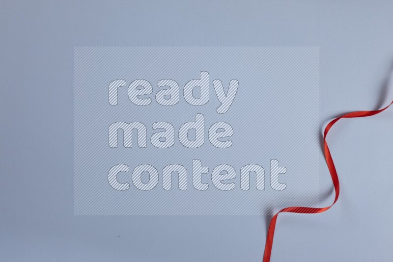 A red collection of sewing and tailoring tools arranged on a blue background