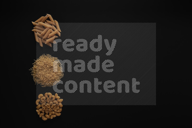 Different pasta types in 3 bunches on black background