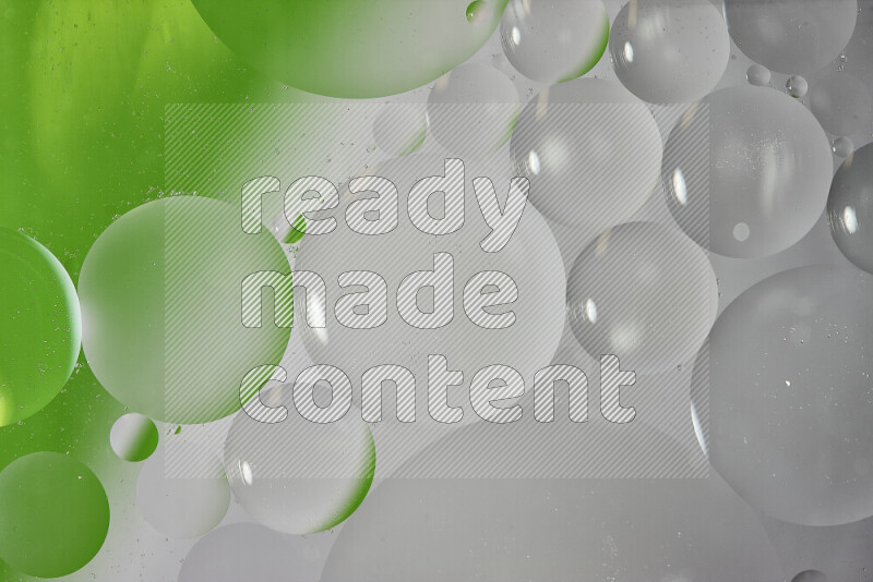 Close-ups of abstract oil bubbles on water surface in shades of white and green