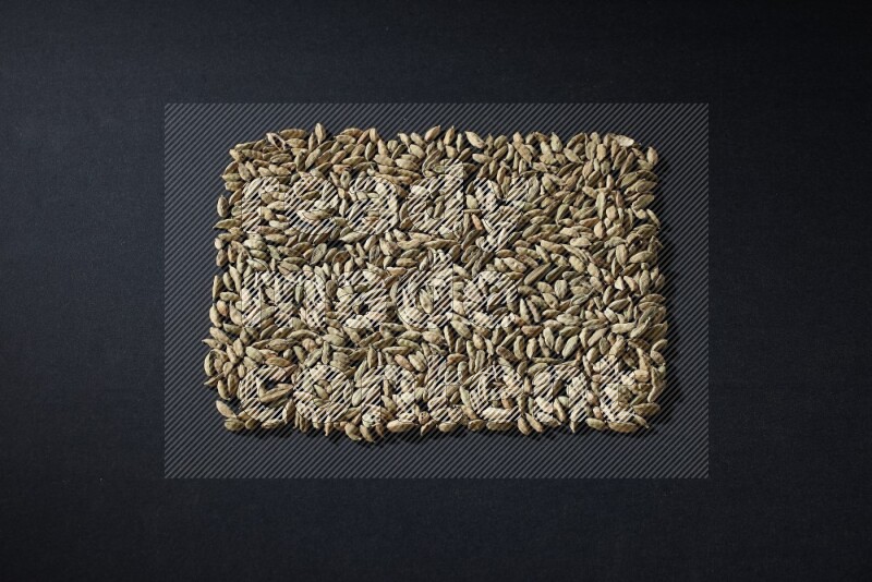 حبوب الهيل على شكل مستطيل على خلفية سوداء