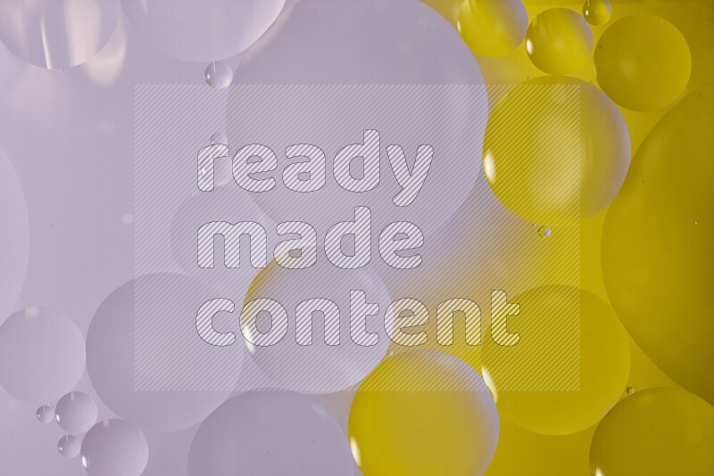 Close-ups of abstract oil bubbles on water surface in shades of white and yellow