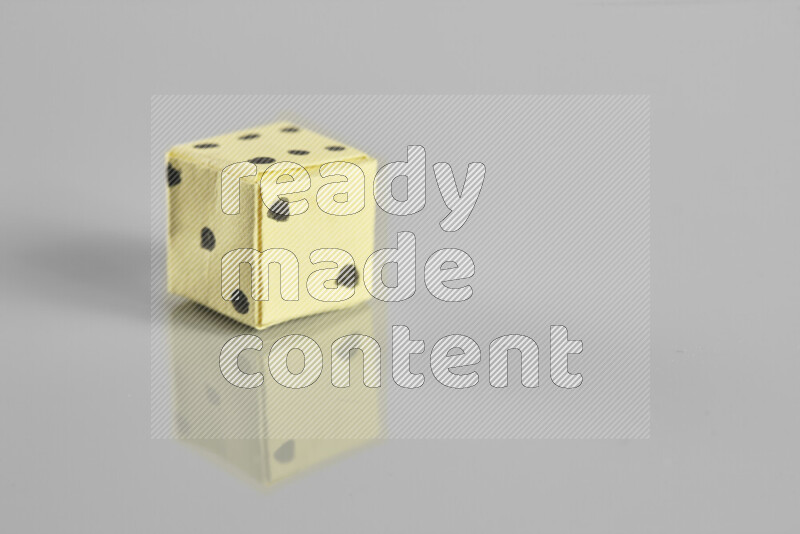 Origami dice on grey background