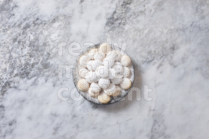 Kahk in black pottery plate on grey marble background