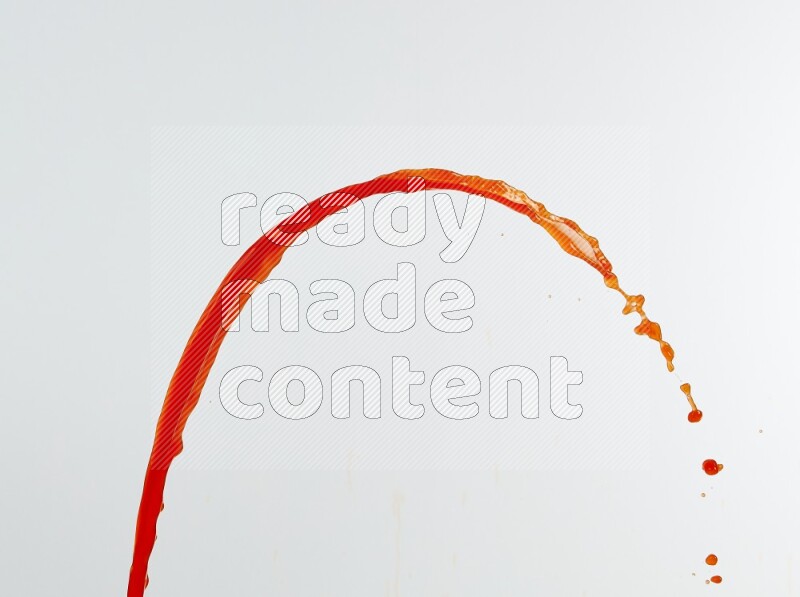 Orange liquid splash and drops on white background