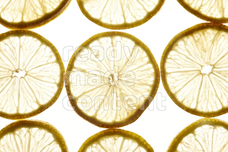 Lemon slices on illuminated white background