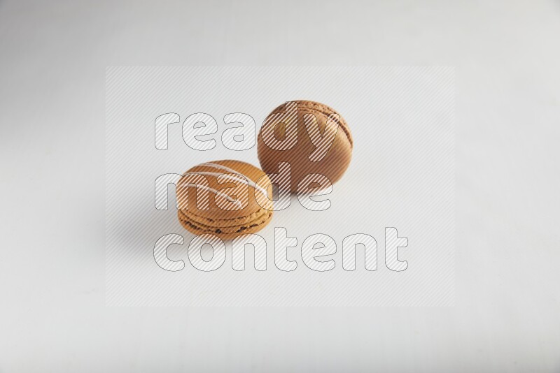 45º Shot of of two assorted Brown Irish Cream, and Brown Coffee macarons  on white background
