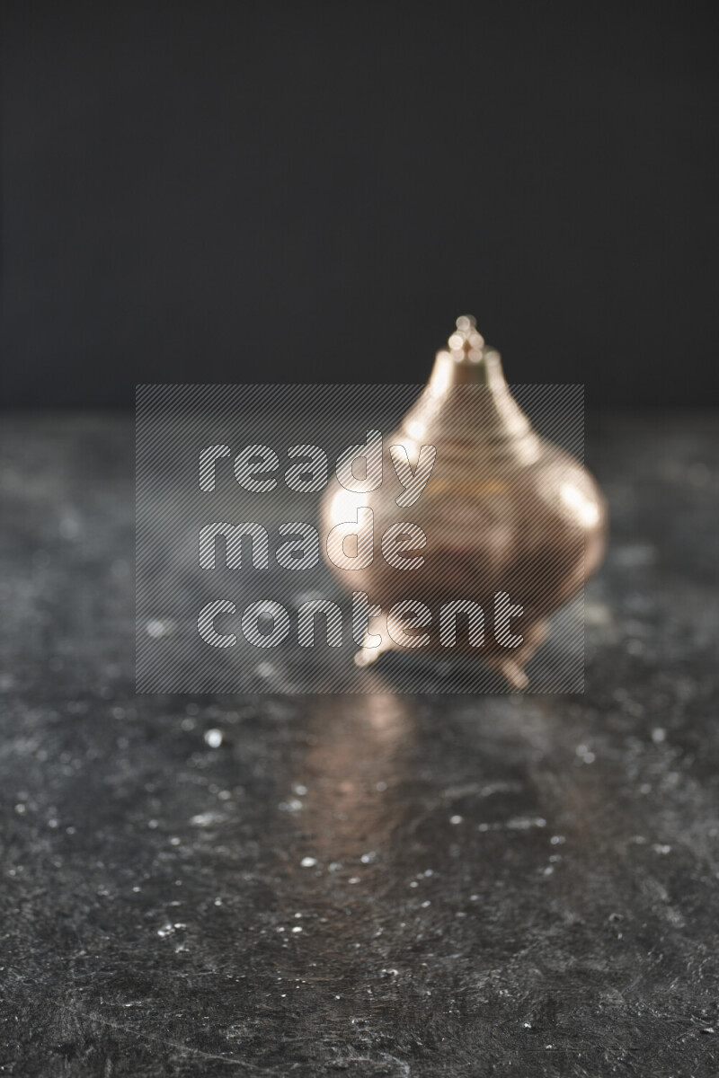 A lantern placed on a textured black background