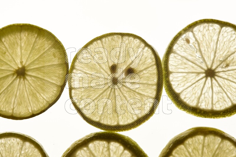 Lemon slices on illuminated white background